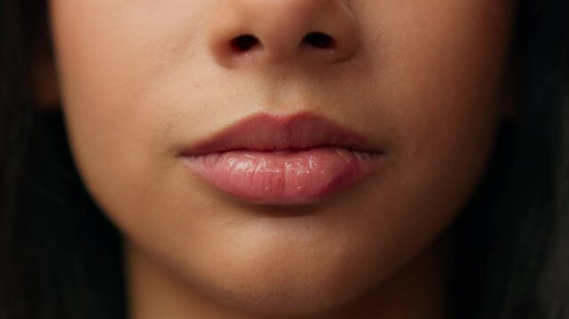 Extreme close up mouth ethnic woman Hispanic latina female girl face details lady seductive lips plastic surgery health care beauty procedure makeup cosmetics lipstick filler smooth skin cropped view