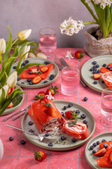 Red velvet crepe cake garnished with fresh strawberries and blueberries for a festive celebration