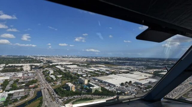 Miami, Florida - approach and landing from Pilots point of view (POV) at Miami International Airport on Runway 12, Cockpit View overflying Miami suburbs before landing  - 4k aerial video footage