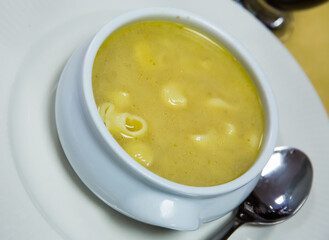 Appetizing warm pasta soup served in bowl