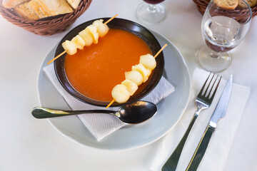 Spanish gazpacho tomato soup with melon slices on skewers. Spanish cuisine