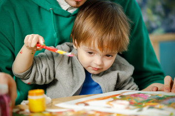 Father and son spend time together painting