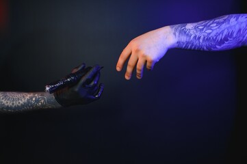 Close up cropped photo of tattooer master artist male hold in hand machine black ink in jar,...