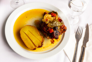 Popular Italian dish Ternasco Al Forn, prepared with delicious young lamb meat and served with vegetables and baked potatoes