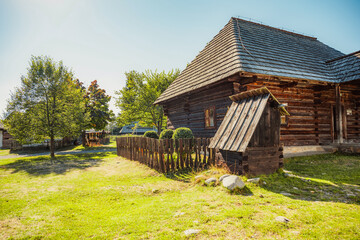Rare wooden bell tower with folk houses located in open-air museum of Liptov Village, Slovakia - Pribylina