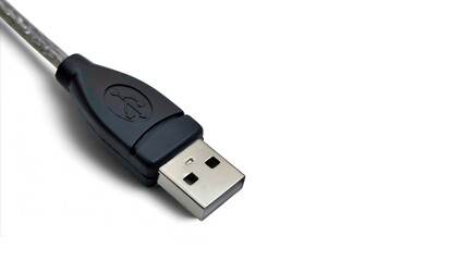 Closeup view of a USB type-a connector, isolated on white background with space for text.