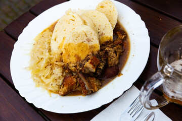 Moravsky vrabec, baked pork with stewed cabbage and boiled potato-dough dumplings, typical czech dish
