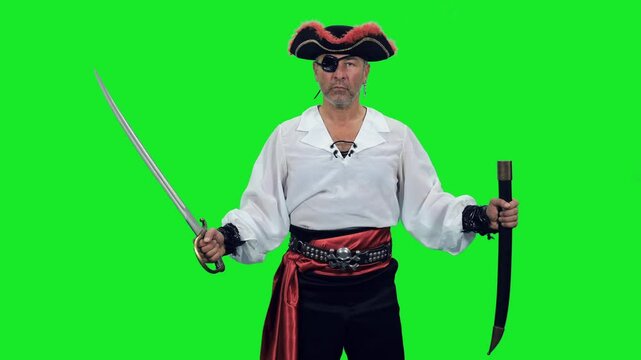Fearless pirate with an eye patch standing with sword on green chroma key background, 4k pre-keyed footage