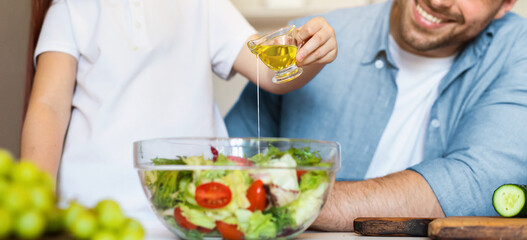 Happy Dad And Daughter Dressing Vegetable Salad With Cooking Oil Preparing Dinner For Family In...