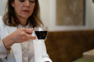 Businesswoman holding a cup of coffee in a cafe
