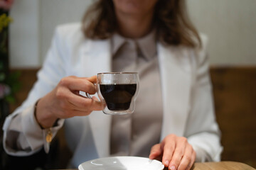 Businesswoman holding a cup of coffee in a cafe