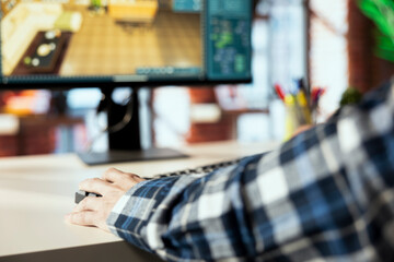 Obraz premium Interior designer uses 3D modeling program, selecting furniture from catalog, dragging objects across floor plan. Close up of man in home office using CAD software, arranging layout, positioning items