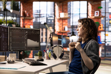 Joyful thrilled woman works on stock trading analysis browsing real time data on her monitors. The digital platform provides financial statistics, forex trends and investment insights.