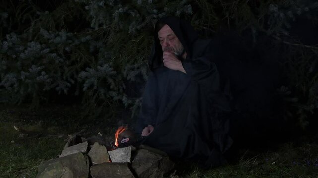 a mysterious sorcerer dressed in a black cloak tos