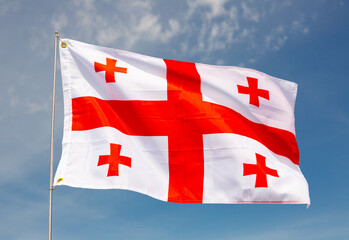 Waving flag of Georgia against a cloudy sky