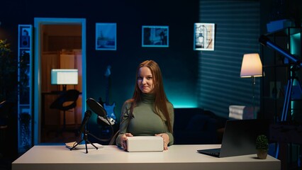 Content creator filming technology review of various electronics, unboxing them and presenting...