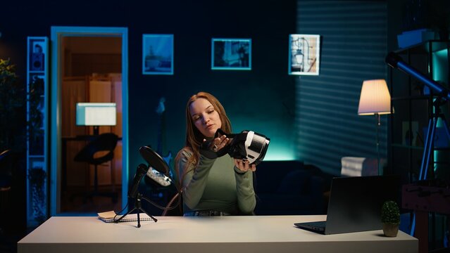 Tech specialist filming sponsored content, unboxing newly released VR glasses product to make fans buy it. Entertainer amazed by product, presenting virtual reality headset to subscribers, camera B - Powered by Adobe
