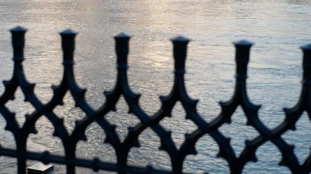 Camera panning revealing budapest cityscape behind bridge railing. Cityscape of budapest, hungary, slowly being revealed by a camera panning behind a bridge railing.