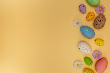 Easter composition made with colorful eggs on beige background. Creative minimal holiday concept.