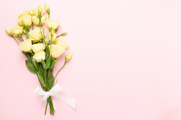 Beautiful bouquet with eustoma flowers on color background, top view