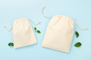 Small eco sacks on color background, top view