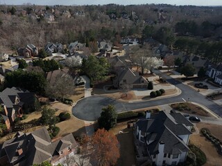 Beautiful aerial view of a sub division with golf course and a beautiful lake in suburbs of Atlanta during golden hour.