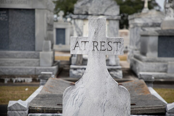 A granite gravestone memorial states At Rest in the Saint Louis Cemetery Number Three in New Orleans, Louisiana. 