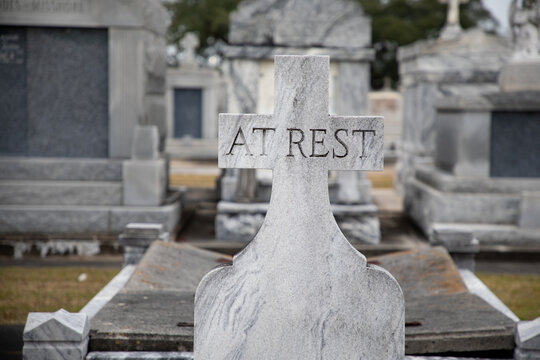 A granite gravestone memorial states At Rest in the Saint Louis Cemetery Number Three in New Orleans, Louisiana. 