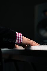 Piano player hands playing keyboard musical instrument music production studio