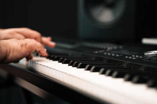 Piano player hands playing keyboard musical instrument music production studio