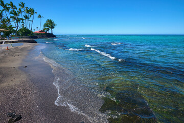 Tranquil Hawaiian Coastline: Black Sand Beach Meeting Clear Turquoise Waters Under Blue Sky - Peaceful Island Paradise
