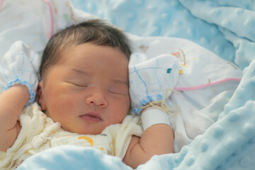 Baby is sleeping in a blue blanket