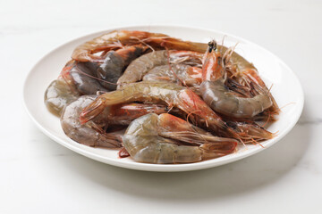 Fresh raw shrimps on white marble table, closeup