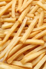 Pile of delicious French fries as background, closeup