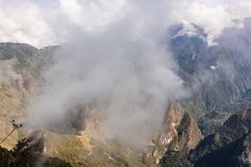 Fototapeta premium Aerial view of Machu Picchu ruins in clouds from Machu Picchu mountain, Peru