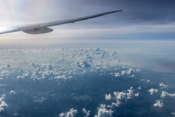 View of an airplane wing above clouds