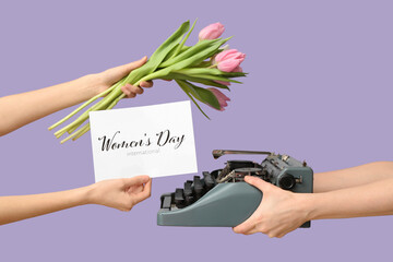 Female hands with typewriter, beautiful tulip flowers and greeting card for International Women's...