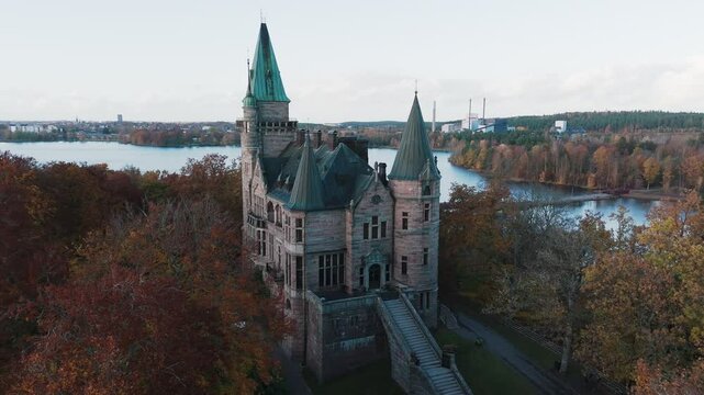 Tracking shot towards Teleborg Castle in V&auml;xjo, Sweden, Fall, Orange and Yellow Leafs
