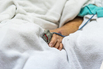 Patient in the hospital with pulse gauge on finger
