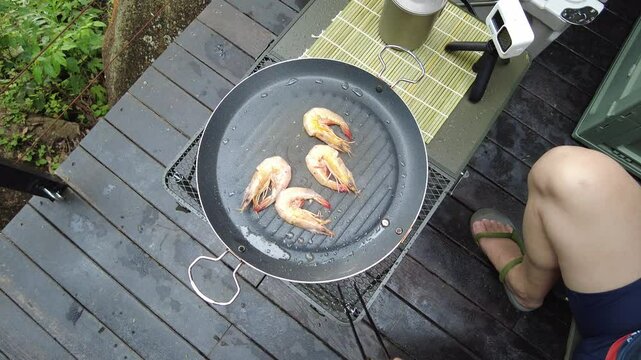 Camping and grilling prawns
