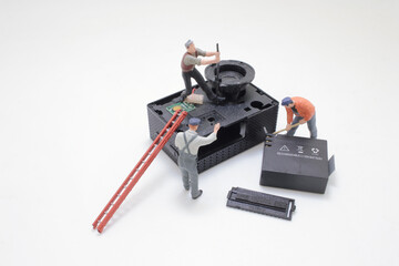 Miniature Workers Repairing a Device With a Thankful Approach
