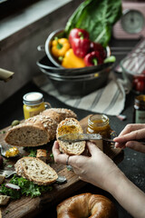 Preparing a delicious breakfast with fresh bread and homemade jam with fresh vegetables