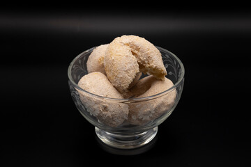 A glass bowl filled with cinnamon sugar cake donuts showcases their golden-brown, sugary coating. The soft, fluffy texture and warm, comforting aroma make these treats irresistible.