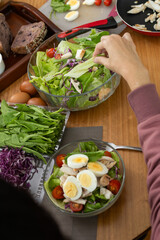 A beautifully arranged table filled with a variety of fresh, colorful salads, each packed with nutritious ingredients, offering a healthy feast perfect for sharing or enjoying alone.

