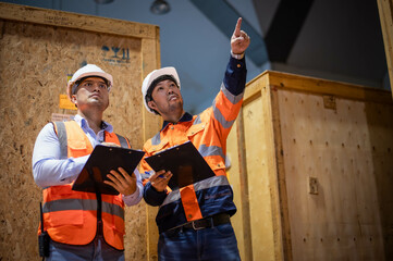 Warehouse inspectors and factory architects are having a meeting to discuss the layout of goods to...
