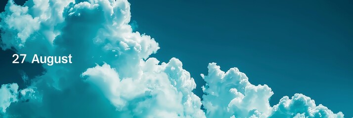 Fluffy white clouds against a vibrant blue sky, creating a serene and uplifting atmosphere on 27 August.
