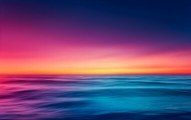 Obraz premium A breathtaking view of a tranquil ocean at sunset, showcasing vibrant hues of pink and blue reflecting on calm waters.