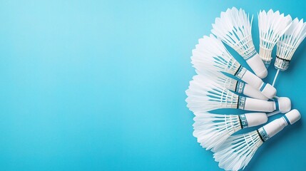 Artistic Arrangement of Scattered Badminton Shuttlecocks on Blue