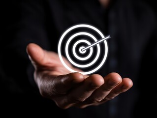 A hand holding a glowing target symbolizing focus and achievement in business.