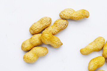 Roasted peanuts in shell on white background.